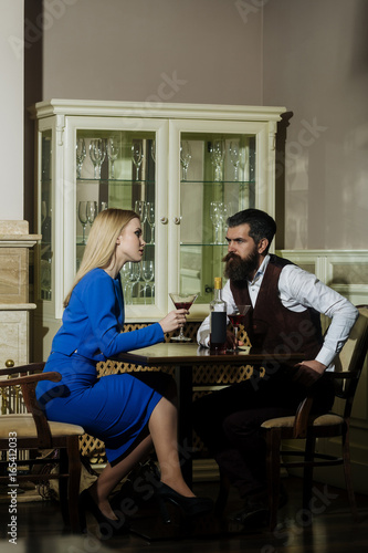 Couple in love sitting with martini glasses at table