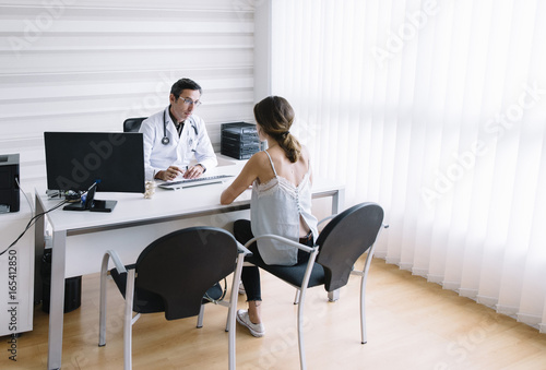 Male doctor with female patient