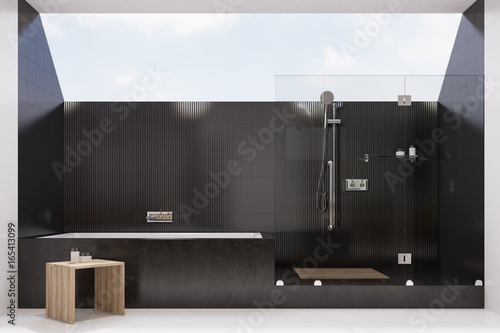 Black tiled bathroom interior, shower