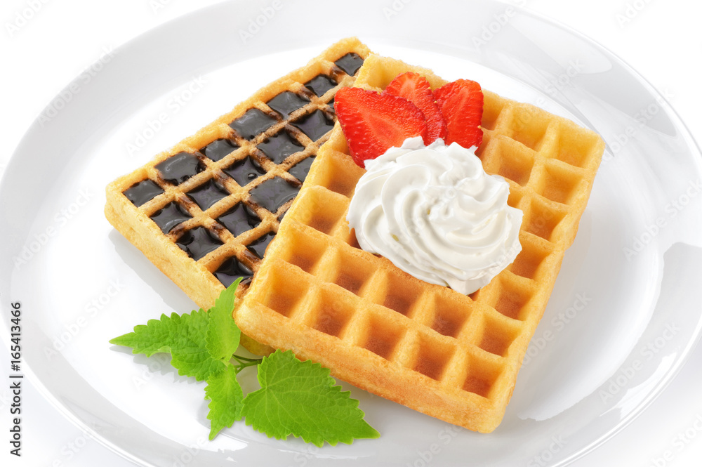 Belgium waffles with whipped cream, chocolate, mint and strawberries. Breakfast. Belgium waffles with whipped cream, chocolate, mint and strawberries. Breakfast.
