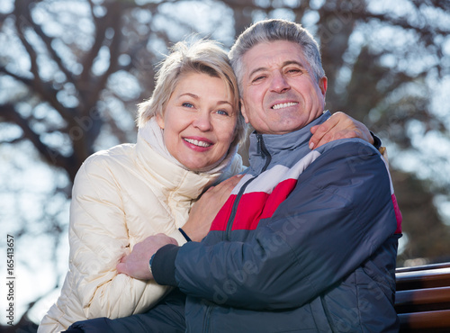 Smiling mature couple relaxing in park