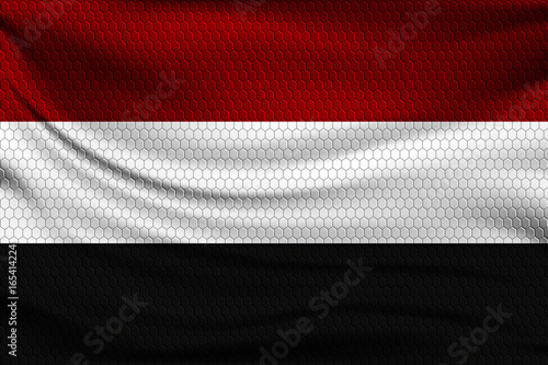 National flag of Yemen on wavy fabric with a volumetric pattern of hexagons. Vector illustration.