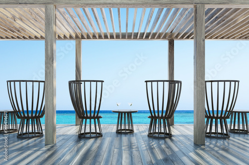 Dark wooden chairs and table, cocktails, seaside