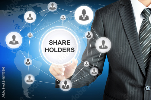 Wall Mural Businessman pointing on SHAREHOLDERS sign on virtual screen with people icons li