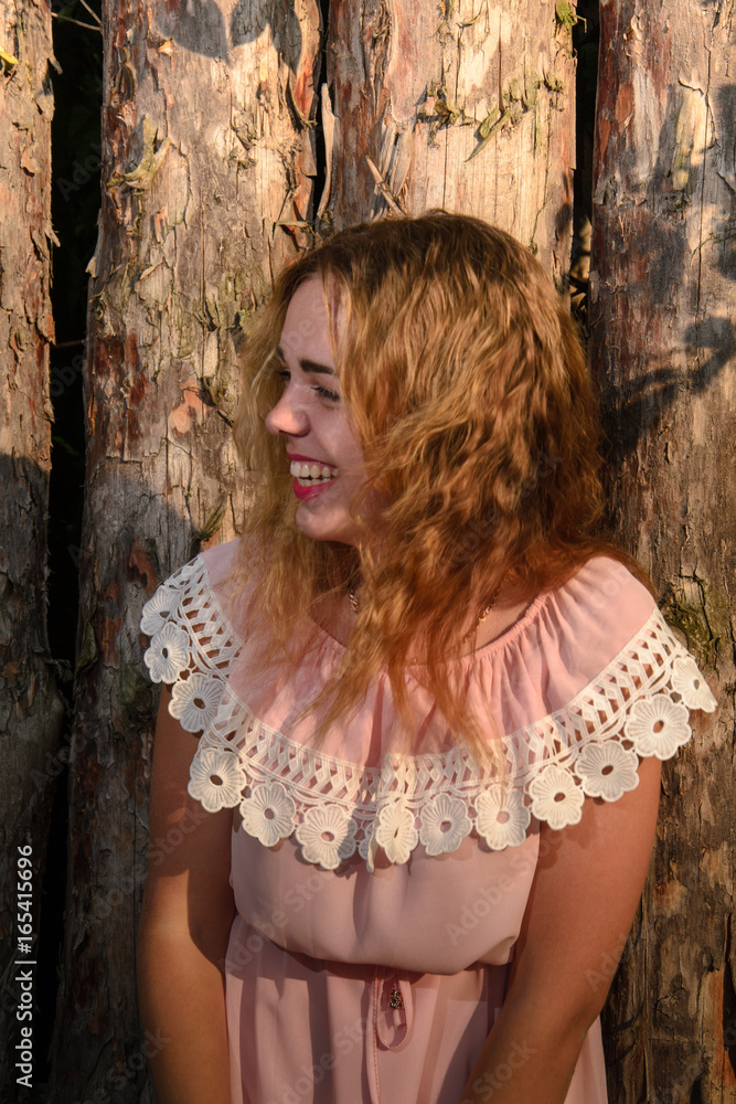 Fototapeta premium Wow. Close up portrait fashionable girl, teenager looking at camera and laughing isolated natural wooden wall. Positive human emotion