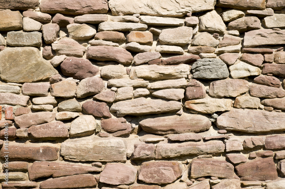 Old red stone wall closeup