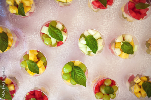 Desserts with mix of fruits in glasses