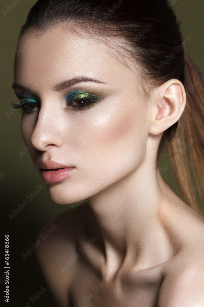 Obraz premium Beautiful young model with fashion make up, perfect skin. Trendy colorful smoky eyes. Green smoky eyes