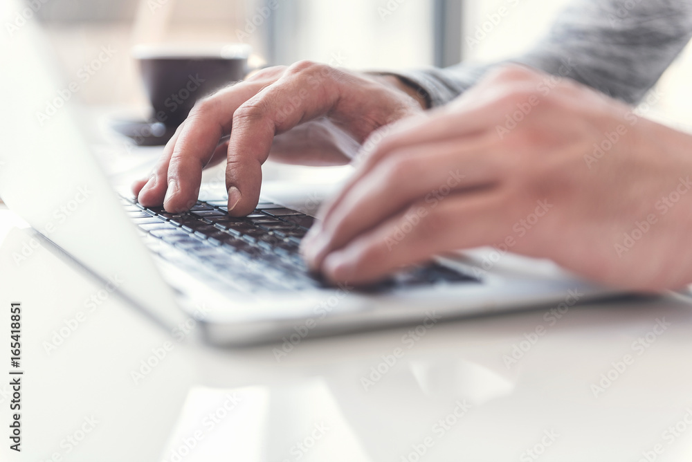 Employee is using modern device while laboring with concentration