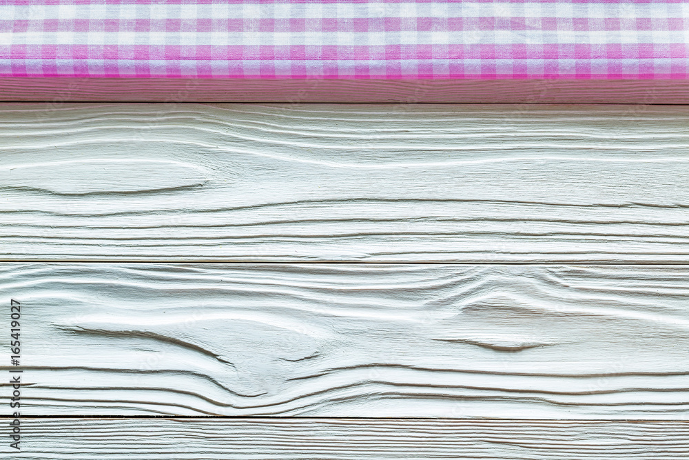 Pink checked table cloth on wooden board Pink checked table cloth on wooden board