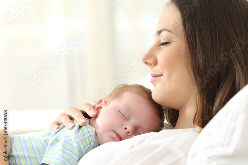 Profile of a happy mother sleeping with her baby