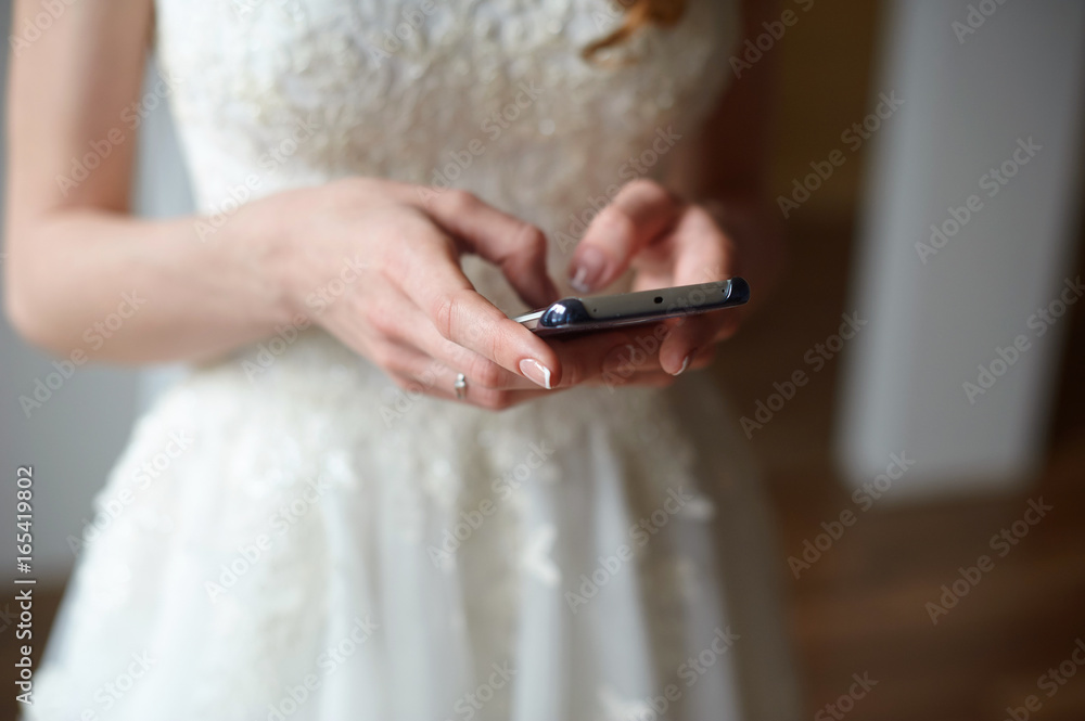 bride with the phone typing a message