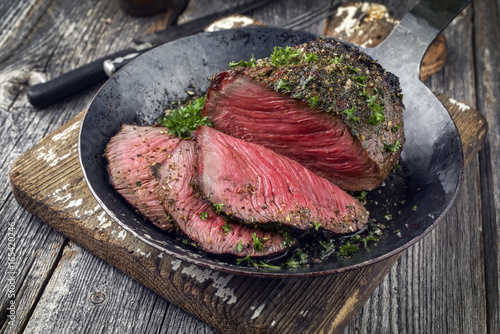 Barbecue Wagyu Point Steak sliced as close-up on an Iron Cast Pan photo