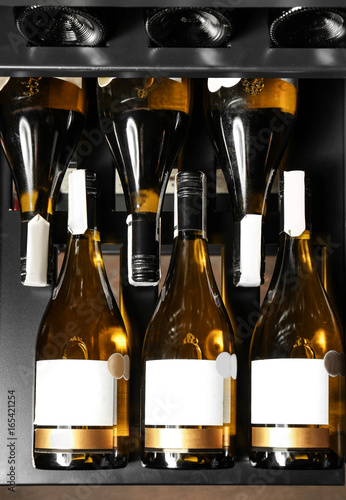 Bottles of wine on shelf at store, closeup