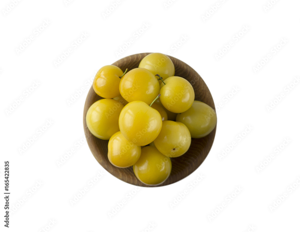 Bowl with yellow plums isolated on white background. Ripe plums with copy space for text. Top view Bowl with yellow plums isolated on white background. Ripe plums with copy space for text. Top view