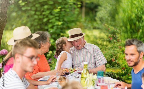  Multi-generation family having lunch in the garden