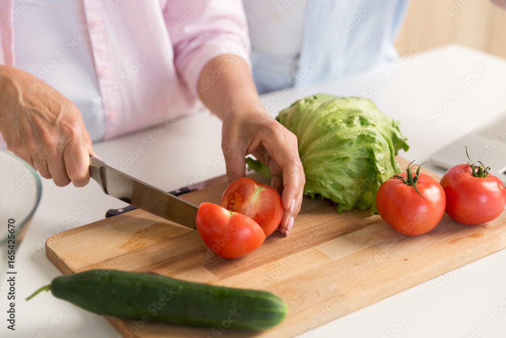 Cropped picture of mature loving couple family cooking. Cropped picture of mature loving couple family cooking.