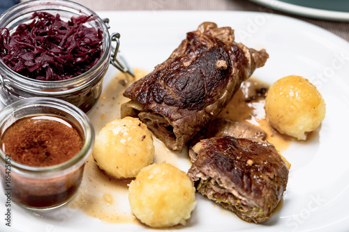 Rinderroulade nach Hausmannsart mit Rotkohl und Kartoffelklößen. photo