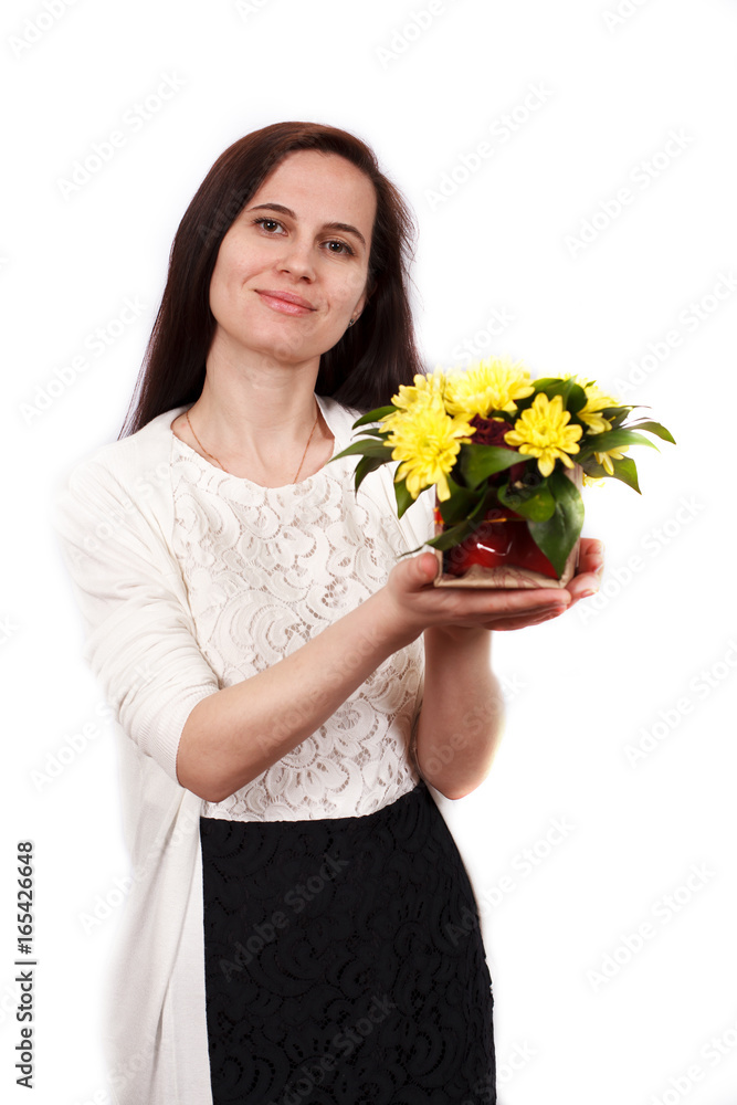 The girl the brunette holds yellow flowers The girl the brunette holds yellow flowers