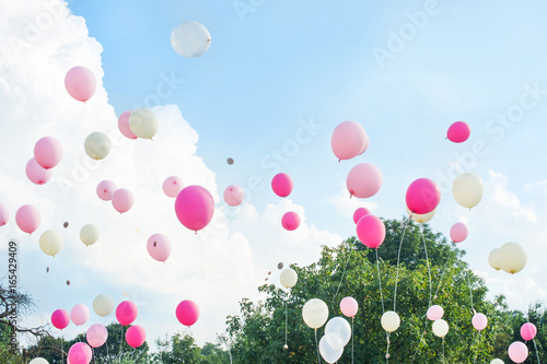 Wedding balloons rise in the sky