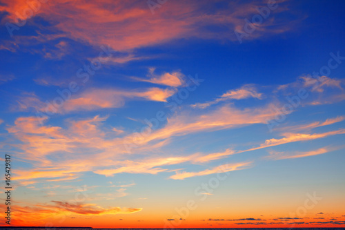 Pink clouds on a blue sky background after sunset