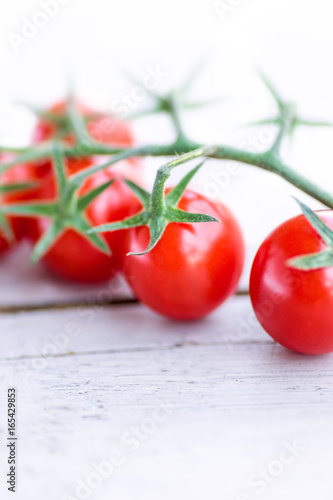 Close-up of a cherry tomato branch on the white background