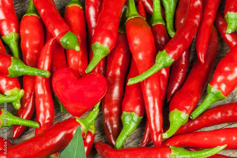 Fresh chili pepper on a wooden board. Growing chili. Healthy spice.