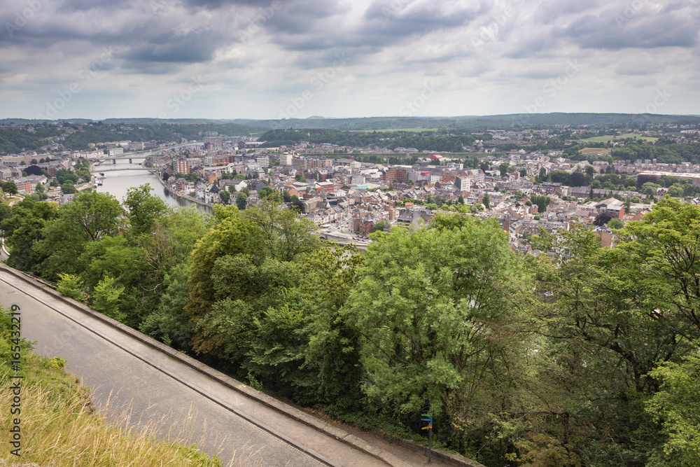 Fototapeta premium The Meuse and Namur under heavy clouds, seen from the citadel