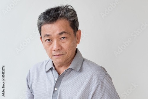angry, upset, unhappy, frustrated, unfriendly middle age old asian man looking at you