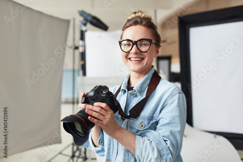 Happy photographer in modern photo-studio photo