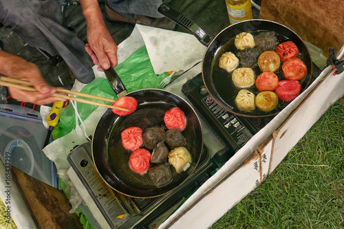 Photography Man prepares dumplings at thai street food outdoor market