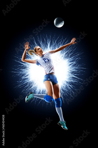 Female professional volleyball player isolated on black © 103tnn