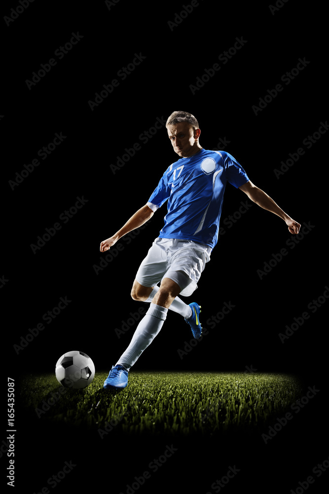 Professional football soccer player in action isolated on black