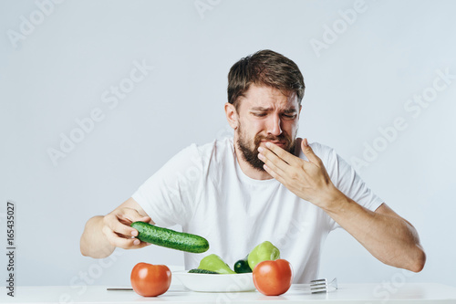 Vegetarian, diet, man with a beard on a white isolated background, nutrition, vegetables, vegetarianism