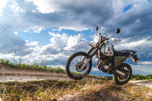 Motorcycle off road, enduro, extreme sport, active lifestyle, adventure touring concept, enduro outdoor view sky clouds freedom