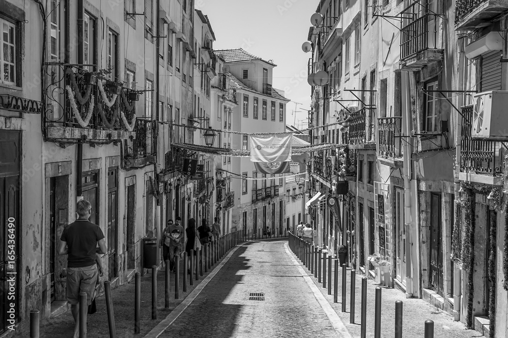 Narrow streets in historic district of Lisbon - LISBON / PORTUGAL - JUNE 17, 2017