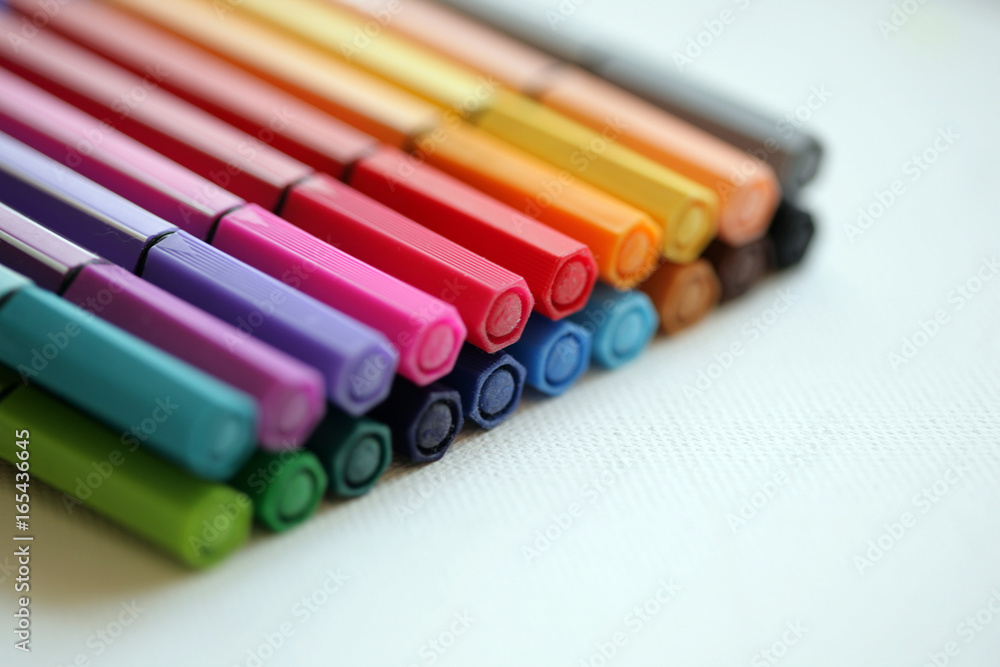 Fototapeta premium Set of coloring pens/markers on white background; close up, selective focus.