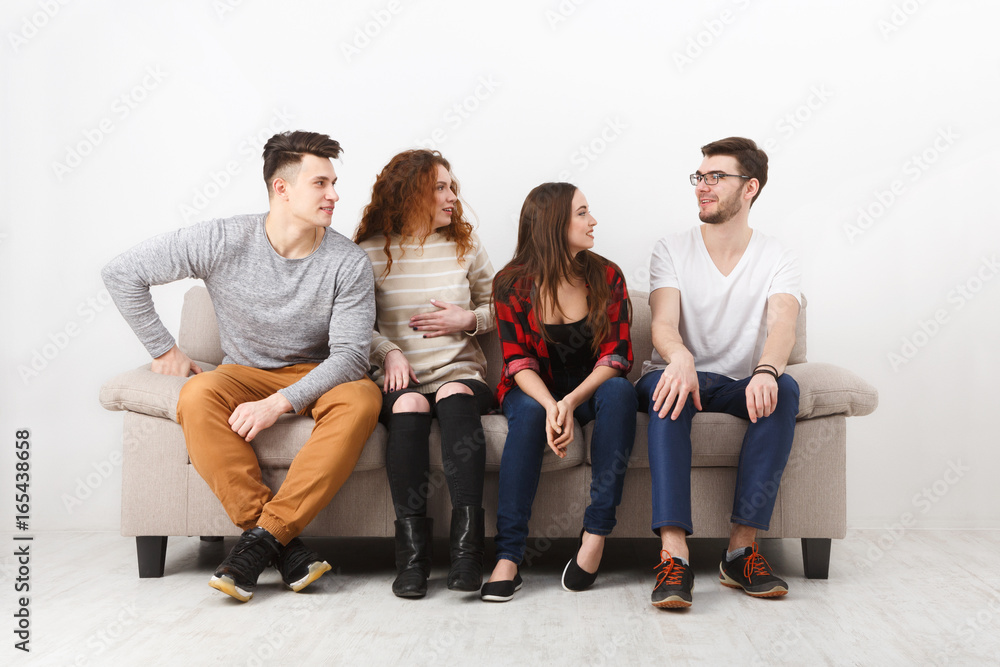Students wait for exam, sitting on couch indoor Students wait for exam, sitting on couch indoor