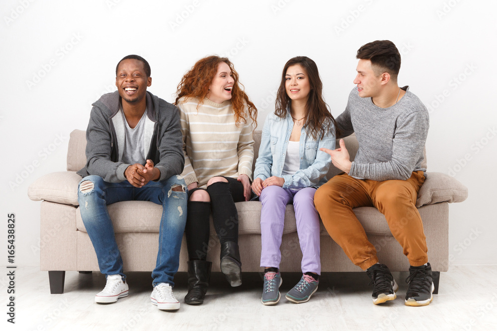 Happy young friends, casual people sitting on couch Happy young friends, casual people sitting on couch