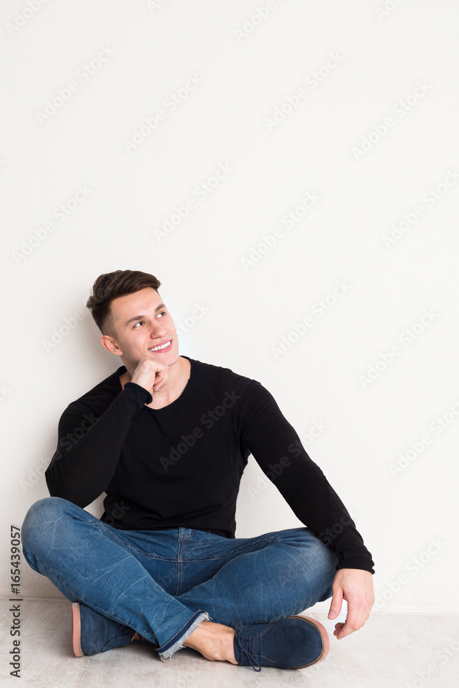 Smiling young man portrait at white studio background. Smiling young man portrait at white studio background.