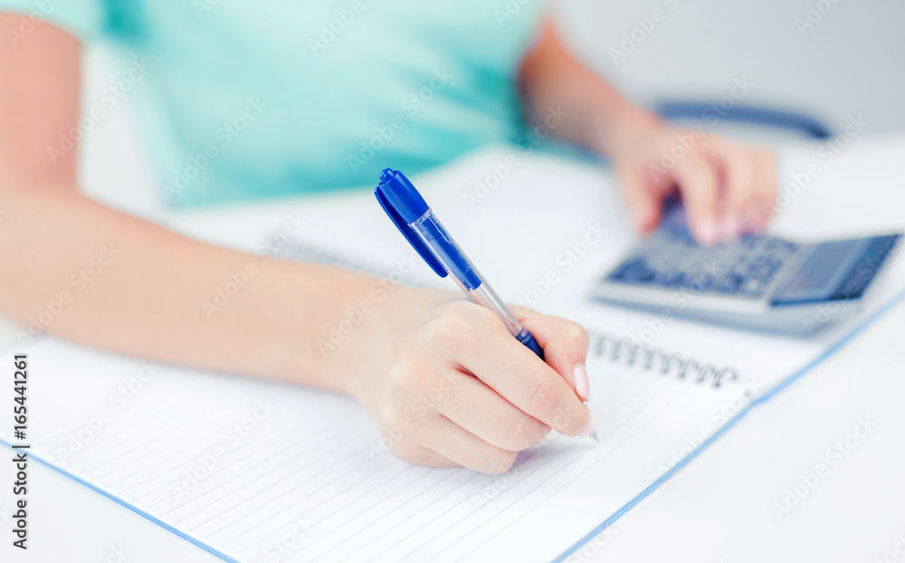 businesswoman working with calculator in office businesswoman working with calculator in office