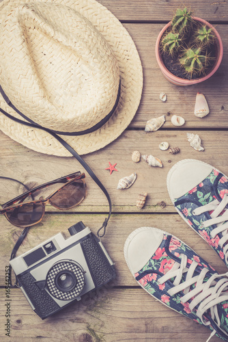 Travel accessories on an old wooden background