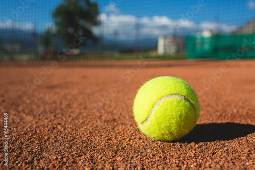 Tennis ball on a court. © Kirill Grekov
