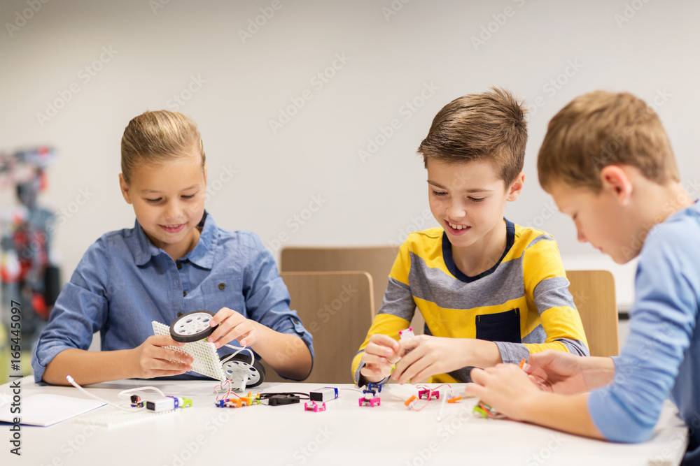 happy children building robots at robotics school happy children building robots at robotics school