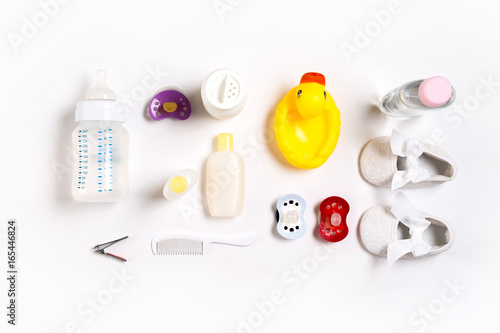 Hairbrush and cosmetics for newborns on a white background. Top view