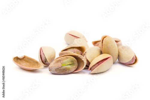 Pile of roasted pistachios isolated on white background