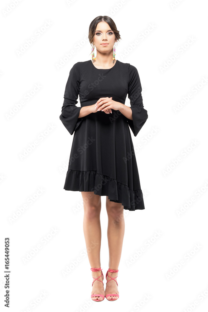 Standing classy formal woman in black dress with hand clasped looking ...