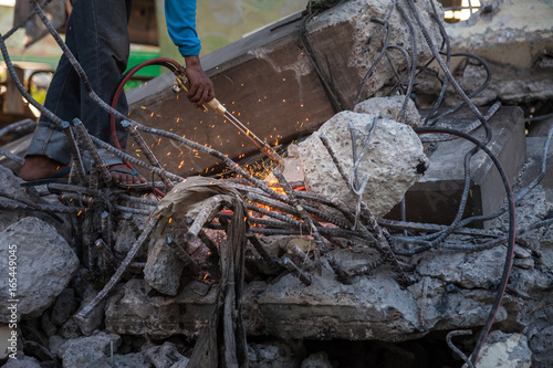 Technician cutting steel with gas and have fire sparkling in site construction.