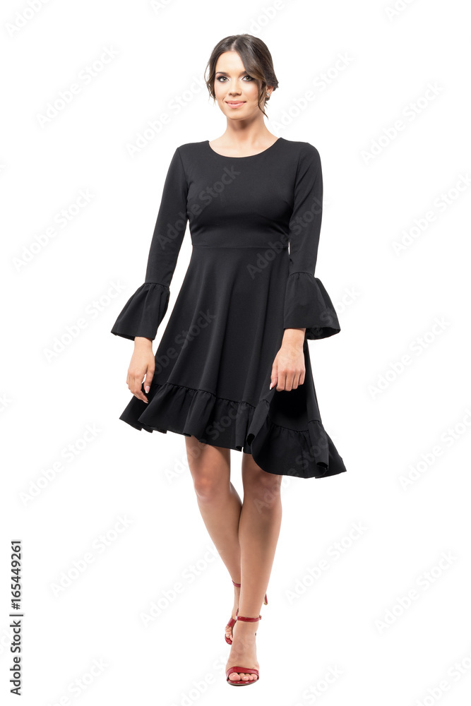 Spinning motion of young hispanic female dancer in black flowing dress. Full body length portrait isolated on white background. Spinning motion of young hispanic female dancer in black flowing dress. Full body length portrait isolated on white background.
