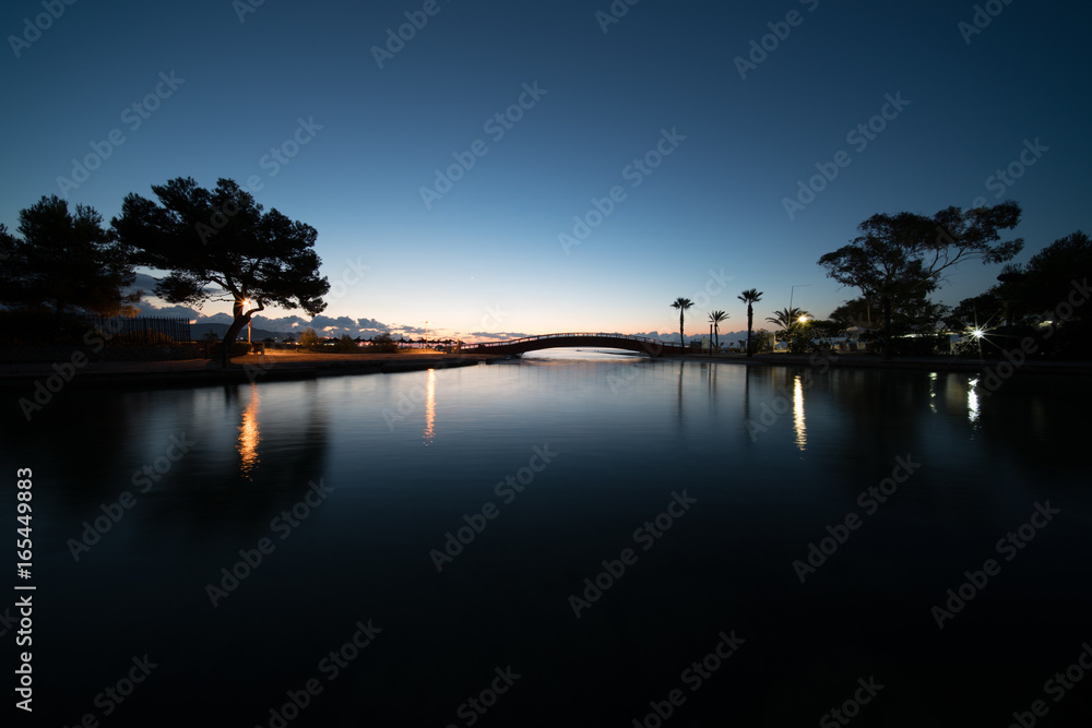 Pond in the park at night with blue sky